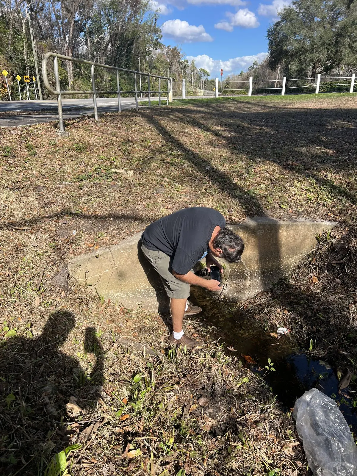 Concrete culvert headwall at a roadside ditch showing drainage contouring results